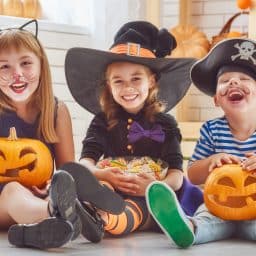 Three young kids in Halloween costumes